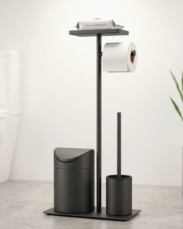 Set de baño negro mate en un baño claro, junto a una planta, con un paquete de toallitas sobre la bandeja